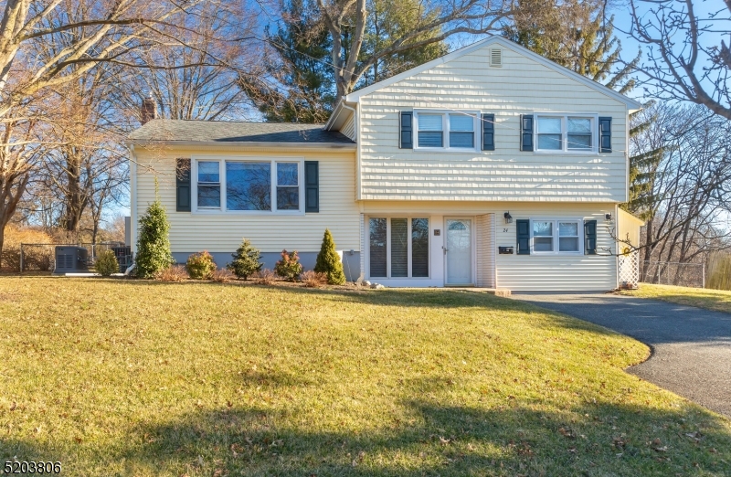 SIMPLY PERFECTION!  Completely updated updated corner lot home, in a low traffic neighborhood!  Be prepared to be WOW'D as you enter through the decorative front door with crescent glass windows into a  large foyer that connects you to rooms adorned with gleaming hardwood floors throughout.  The entry level balcony with diagonal tile flooring and recessed ceiling lights lead you to the lower level of this gorgeous home.  Made for entertaining, the open floor plan connects the Kitchen, Living and Dining Room seamlessly.  The newly remodeled Kitchen is jaw-dropping.  Complete with a Cherry Breakfast Bar with Black Granite Counter and Cabinets offering added counter space and storage.  Granite counter tops with a full subway tiled backsplash coupled with top of the line appliances leave this Kitchen nothing short of perfection!  The four-season porch with deck flooring and two ceiling skylights give way to the views and entrance to the expansive backyard; this just screams ENTERTAIN WITH ME!  Large bedrooms featuring hardwood flooring and wall to wall carpeting.  Master Suite with Master Bathroom conveniently located on the ground level floor.  THIS RARE GEM WON'T LAST LONG!!!