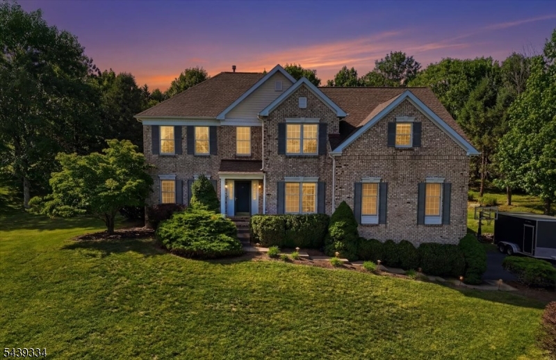 Perched atop one of Hunterdon County's most scenic ridgelines, this beautifully maintained Toll Brother's Federal Colonial offers breathtaking views, timeless elegance, and exceptional indoor-outdoor living. The thoughtfully designed floor plan features 9-foot ceilings, a dramatic two-story family room, formal living and dining rooms, a private office, and a spacious bonus media room.The gourmet kitchen showcases granite countertops, a center island, Viking six-burner gas cooktop, and upgraded stainless steel appliances. Upstairs, the luxurious primary suite features a sitting room, custom walk-in closet, and spa-like bath. A partially finished walk-out basement provides additional flexible living space. Step outside to your private backyard oasis featuring a stunning saltwater pool, elegant paver patio, and professionally designed landscaping. The pool area is beautifully fenced for added safety and comfort, while the property's elevated setting provides breathtaking panoramic views. Additional highlights include a designer laundry room and major mechanical updates, including two-zone HVAC with both furnaces and AC units replaced approximately four years ago.Meticulously maintained throughout, this exceptional 4-bedroom, 2.5-bath offers the perfect blend of luxury, comfort, and modern convenience.