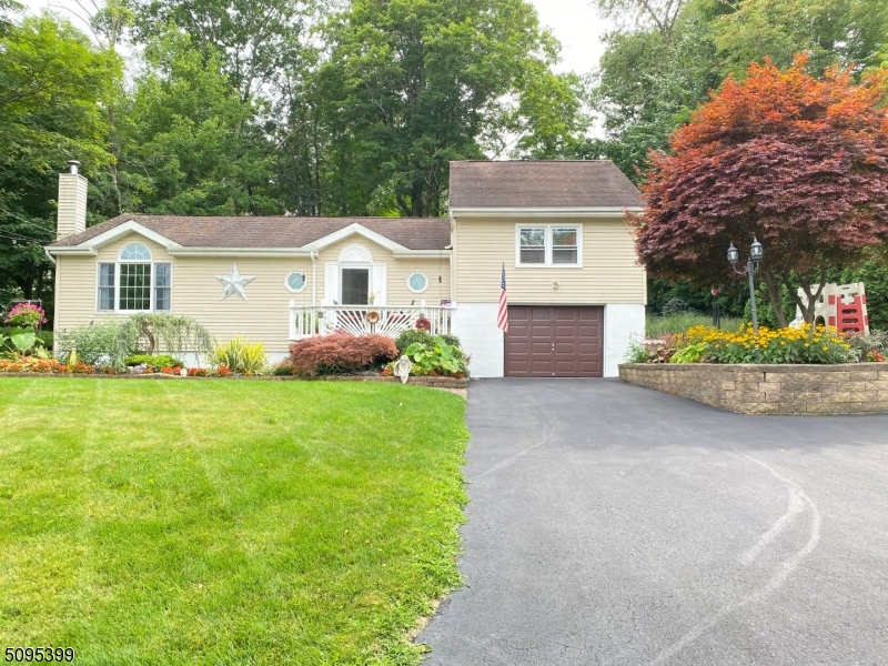 Pride of Ownership radiates throughout this meticulous Expanded  Ranch.  Designed for today's living with open floor plan & custom details.  Enjoy the Lemonade porch & beautiful landscaping. Kitchen offers Breakfast Bar, Granite & Stainless Steel Appliances.  The wall of Custom Arch Windows grace the Family Room with Vaulted Ceilings & Formal Dining Area with plenty of Natural Light.  Gleaming Hardwood Floors throughout.  Sliders lead to a large Deck that over looks a Manmade Pond & Fire Pit with the Back Yard backing Woods for Privacy.  Added Bonus include Central A/C, and Heated Garage.  Come enjoy all that Vernon Township has to offer - hiking. skiing, boating, water parks, swimming, fishing and hunting.  This beauty is calling you home.