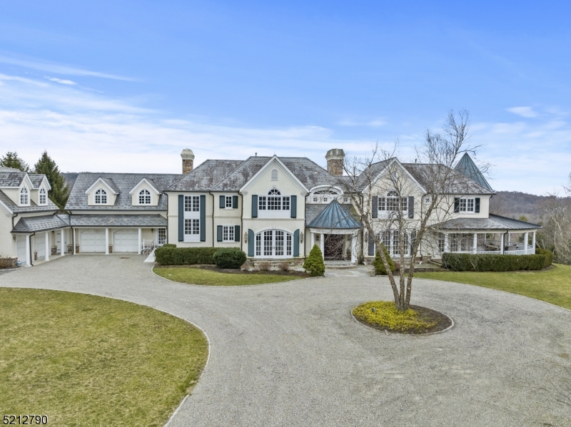 Welcome to your dream home! This custom-built masterpiece boasts over 7,000 square feet of luxurious living space, with 5 bedrooms, 5 full baths, and 2 half baths. As you step through the front door, you'll be greeted by an open layout that is both spacious and inviting. The first floor features a beautiful dining room, a stunning office with a wood-crowned ceiling, a great room that features soaring cathedral ceilings and a giant fireplace, an eat-in kitchen complete with a large island and lots of cabinetry and a glass filled sunroom. The second floor has five bedrooms and five full Baths which includes a beautiful Primary with a fireplace, his and her full bathrooms and 2 walk-in closets. All the rooms in this home are filled with natural light creating a bright and energetic atmosphere. Walk outside on the 3000 sq ft wrap around porch and stand atop the rolling hills, greeted by breathtaking views that stretch out before you. The lush, verdant trees that cover the landscape create a stunning backdrop as the birds soar through the air. These majestic views create a serene feeling like never before. Close proximity to NYC....Location, Location, Location!!!