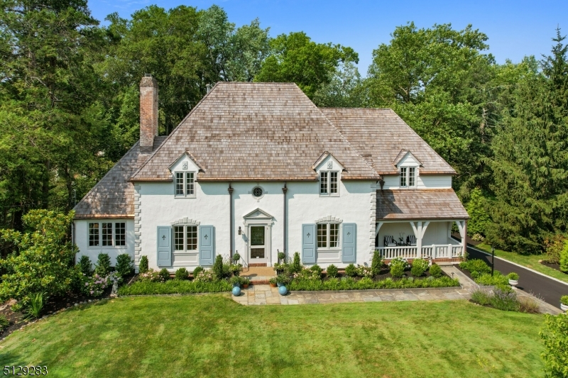 This elegant and exquisite French provincial home recently underwent a major renovation to include high-end designer kitchen (complete with white custom Yorketown cabinetry, quartz countertops, La Cornu gas range/double oven and hood, Sub Zero refrigerator, Miele dishwasher, Shaws farmers sink, etc...) - spacious and bright breakfast area features custom glass cabinetry and built-ins and direct access out to deck with custom awning. Floor plan provides perfect space for entertaining both for formal and informal gatherings. First floor den or library (with built-ins) can be a home office which is tucked away behind the living room. Family/great room is highlighted with threewalls of windows bringing in a tremendous amount of light and overlooks the lush backyard and patio area. The second level has also been renovated with the primary suite which includes a custom built dressing room and spa-like elegant bath (freestanding soaking tub within the oversized walk-in glass shower!!!!)  Four addtl bedrooms and two renovated full baths with a full laundry room (washer and dryer included) complete the 2nd floor. Lower level (walk out to backyard and patio) offers the ideal au-pair or guest ste with full bath or great space for exercise room (currently being used as) and a bonus recreation room complete with wood-burning fireplace, storage room and direct access into 2 separate garages (3+ spaces total). Mere blocks to town center, shopping and train. Chimney/flue/fireplaces "as-is"