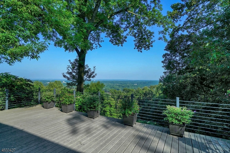 Stunning 4 bedroom, 3 bath colonial with breathtaking view. Professionally landscaped & meticulously manicured w/ picturesque gardens in highly desired Morristown. Welcome guests into the foyer of this sunny & bright home. Escort visitors into the spacious living rm w/ hardwood floors & wood-burning fireplace, or entertain in the formal dining rm. The updated kitchen features abundant cabinets, tile floors & updated appliances. The sun-drenched breakfast area is the ideal place to start the day. Relax in the family rm, or unwind on the oversized deck w/ an extraordinary view all the way to the Manhattan! The exquisite master suite features a separate sitting area & custom walk-in closet. The sumptuous master bath has custom tile & spa-like shower. 3 additional bedrooms provide plenty of space for guests.