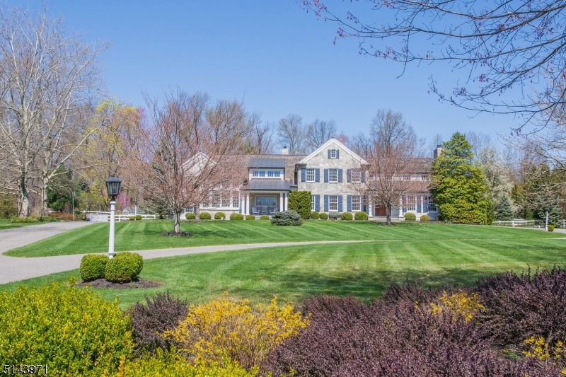 EXTRAORDINARY COUNTRY HOME - This tastefully updated custom colonial is situated at the end of a private lane off a most picturesque Harding road. Classic yet modern, this light-filled home offers a thoughtful combination of open and private spaces for work, play and entertaining. The flat bucolic property features a saltwater POOL, bluestone patios, raised garden beds, a pergola, a gazebo and a rustic barn. The centerpiece of the carefully conceived first floor is a sophisticated and spacious eat-in kitchen perfectly situated adjacent to the family room and its adjoining patios, wet bar, sun room and formal dining room. Also on the first floor is a formal living room, wood-paneled office with half bath and second wet bar, a solarium with wood stove, one of two laundry rooms, and a bedroom with full bath. Upstairs houses the primary bedroom featuring a stunning beamed cathedral ceiling, two full baths and two walk-in closets. There are four additional bedrooms on the second floor, another laundry room, and a flexible space that could be used as a second office or exercise room. This private country compound is ideally located less than six miles from vibrant downtown Morristown and 40 miles from midtown Manhattan.