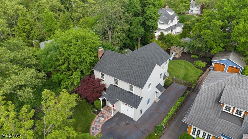 Nestled in Westfield's sought-after Gardens neighborhood, this beautiful expansive 4-bedroom, 4-bath Colonial offers the perfect blend of classic charm and modern living. A substantial two-story addition creates generous living space, including a sun-filled living room with a wood-burning fireplace, an updated kitchen with quartz countertops, tiled backsplash, abundant cabinetry, and built-in breakfast seating. The spacious family room features custom built-ins, a gas fireplace, and French doors that open to a private backyard retreat with a patio, mature landscaping, grapevines, and fruit-bearing peach and plum trees.The second floor features a stunning primary suite with vaulted ceilings, two walk-in closets, a private office, and an en-suite bath with a soaking tub. Three additional bedrooms and an updated hall bath complete the upper level. The finished lower level offers a recreation room, exercise room, full bath, laundry area, and ample storage. Additional highlights include hardwood floors throughout, custom millwork, crown moldings, three-zone central air, three gas furnaces, EV charging, and a roof replaced less than two years ago. Ideally located in the Franklin School District and just minutes from downtown Westfield, parks, shopping, dining, and NJ Transit.