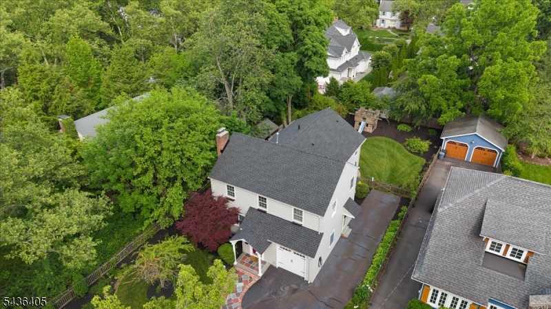 Nestled in Westfield's sought-after Gardens neighborhood, this beautiful expansive 4-bedroom, 4-bath Colonial offers the perfect blend of classic charm and modern living. A substantial two-story addition creates generous living space, including a sun-filled living room with a wood-burning fireplace, an updated kitchen with quartz countertops, tiled backsplash, abundant cabinetry, and built-in breakfast seating. The spacious family room features custom built-ins, a gas fireplace, and French doors that open to a private backyard retreat with a patio, mature landscaping, grapevines, and fruit-bearing peach and plum trees.The second floor features a stunning primary suite with vaulted ceilings, two walk-in closets, a private office, and an en-suite bath with a soaking tub. Three additional bedrooms and an updated hall bath complete the upper level. The finished lower level offers a recreation room, exercise room, full bath, laundry area, and ample storage. With approximately 3,553 square feet of living space, this home offers exceptional comfort and versatility. Additional highlights include hardwood floors throughout, custom millwork, crown moldings, three-zone central air, three gas furnaces, EV charging, and a roof replaced less than two years ago. Ideally located in the Franklin School District and just minutes from downtown Westfield, parks, shopping, dining, and NJ Transit.