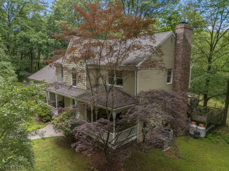 Re-entering for Comp purposes - Welcome to your private retreat in picturesque Bethlehem Township! Nestled on nearly 7 wooded acres, this 4 bedroom, 2.5 bath colonial offers the perfect blend of privacy, comfort, and charm. Step inside to a spacious open foyer that sets the tone for the thoughtfully designed main level. You'll find a formal dining room, a versatile living room, and a bright kitchen with multiple pantries and a breakfast nook overlooking the serene backyard. The adjacent family room, complete with a high efficiency fireplace insert, is ideal for cozy evenings. Practicality meets style with a mudroom entry from the garage, a convenient laundry room, and a half bath on the first floor. Upstairs, the spacious primary suite features a walk-in closet, fireplace, and full en-suite bath. Three additional bedrooms and another full bath complete the second level. The partially finished basement offers a versatile rec room, home office/music room, plus ample workshop and storage space. Outdoor living shines with a charming covered front porch, multi-level back decks, and a stunning heated gunite pool with a rock waterfall and built-in hot tub for your own backyard oasis. Last but certainly not least, a built-in generator (2023) and BRAND NEW SEPTIC were installed to ensure peace of mind. This home offers the space, setting, and flexibility to live, work, and entertain in style. Don't miss this rare opportunity to own a beautiful home in a peaceful and private location!