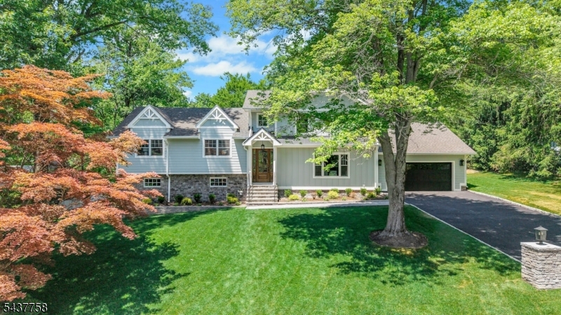 Experience elevated living in this European-inspired custom new construction, positioned in one of North Caldwell's most sought-after neighborhoods.  this 5-bedroom, 3 full and 2 half bath luxury residence blends timeless architecture with a sophisticated modern aesthetic. The entire upper level is dedicated to a private primary suite, offering a serene retreat with a spa-like bath featuring a soaking tub, glass-enclosed shower, dual vanities, and walk-in dressing areas. The main level showcases a bright open floor plan ideal for entertaining, including a chef's kitchen with top-tier appliances, quartz countertops, custom cabinetry, and an oversized island that flows into the family room with gas fireplace and sliders to the yard. A formal dining room, butler's pantry, and flexible office or den add versatility and elegance. The walk-out lower level offers an additional half bath and space for a gym, media room, or guest suite with direct outdoor access. Step outside to a serene, oversized wooded backyard, the perfect setting for a future pool, patio, or outdoor entertaining area. Thoughtful design details include white oak floors, custom millwork, designer lighting, and expansive windows that flood the home with natural light. Conveniently located 20 miles from NYC with top-ranked schools, parks, and major highways.