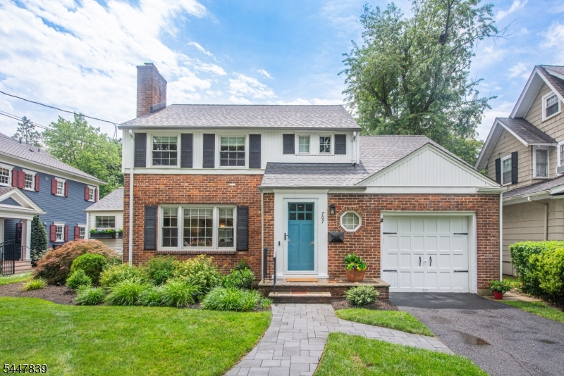 Abundant natural light fills this classic Colonial, which features thoughtful renovations and a comfortable indoor-outdoor flow. With an eye on design and lifestyle, smart updates can be found in the kitchen, family room, bathrooms and basement. The spacious living room, complete with a wood-burning fireplace, is ideal for everyday gatherings and entertaining. The bright kitchen and dining area include quartz countertops, a breakfast bar, under cabinet lighting, generous counterspace, and stainless-steel appliances, including a five burner stove. A versatile family room can also serve as a guest room or home office, with sleek barn doors that can provide additional privacy. A first fl, 1/2 bath offers everyday convenience. Upstairs, three generously sized bedrooms and main bath are thoughtfully separated from the home's main entertaining areas. Outside, the property is professionally landscaped, hardscaped and irrigated (2025).  Enjoy a true at-home oasis from your backyard patio with an expansive, green view. The finished basement is perfect for watching movies, a gym, or home office, while the separate laundry room offers additional storage and space for crafts or projects. Ideally located in Westfield, this beautiful home provides convenient access to town, schools, transportation, major roads and Newark Liberty International Airport.