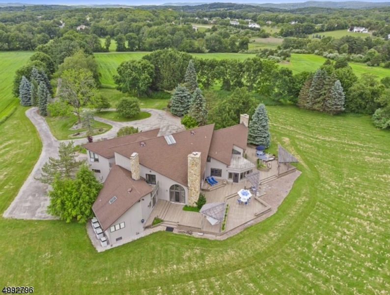 Welcome to 175 Warbasse Junction.  Extremely Private Estate offers over 6000+sqft with 53.70 Open Acres of Land.  This Home has a Grand Entry that also features a sunken Wet Bar area. 5 BDRMS 4 1/2 BA w/3 Car Garage, The full unfinished Basement has Drive-In access, A workshop area, A stone fireplace and other rooms that could easily be finished into Wine Cellars, Media Rooms, etc.  The upstairs of the Home offers an Open Room overlooking The Family Room, A Sauna Room, Access to one of the many Upper Decks, 3 Additional Bedrooms and An amazing oversized Playroom, Game Room over the Garage features Great Character w/Multiple Skylights & Plenty of light.  In the Main Level of the Home, A Master Suite with sitting/working area, Double Closets, Steam Shower, Radiant heated walls around the tub.