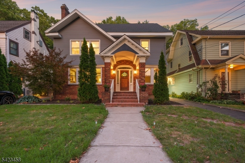 Experience the perfect blend of modern luxury and architectural details in this fully renovated Colonial, ideally situated in Maplewood's popular College Hill section. Finished across four spacious levels and refreshed inside and out--there is room for everyone here! Step inside and be captivated by gorgeous curved Maple moldings and trim, stained glass windows, built-ins, high ceilings, and a cozy gas fireplace in the living room. This smart home features a new 2-zone high-efficiency HVAC system managed by two new Nest thermostats for year round comfort. Gleaming refinished floors flow through the freshly painted interior, illuminated by new designer light fixtures and complemented by new solid-core interior doors. The new gourmet kitchen is a chef's dream, boasting custom quartz countertops and backsplash, premium Bosch and LG SS appliances, a built-in wine fridge, breakfast nook, and a classic Butler's pantry. Relax in the 3.5 completely new baths showcasing stylish designer tile, heated floors and premium fixtures. The Lower level boasts a Rec Room and a bonus room with an ensuite bath. The exterior boasts unmatched curb appeal with a new roof, new premium siding, freshly painted exterior trim, and new Pella windows. Enjoy the outdoors on the new Trex deck overlooking the backyard and appreciate the curb appeal of a newly paved driveway,  smart myQ garage doors, new metal railings, a new sidewalk, and new elegant exterior lights. A rare, flawlessly updated turnkey gem!