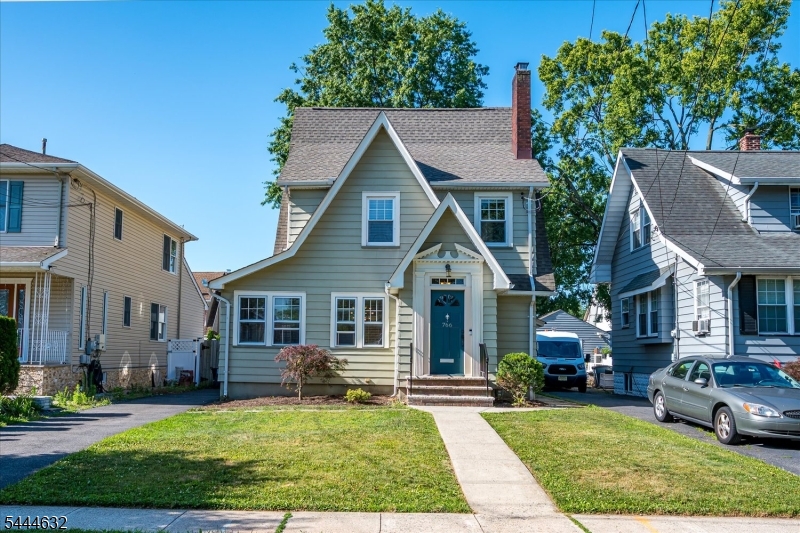 Welcome to this charming "Storybook" English Cottage in the heart of Rahway! This 3-bedroom, 1.5-bath home perfectly blends classic character with modern updates, including a generator bypass switch with outdoor outlet.  Step inside to find a spacious living room featuring a gas fireplace and elegant molding, flowing into a formal dining room perfect for entertaining. The updated kitchen shines with a lovely ceramic backsplash and newer flooring. Beautiful hardwood floors run throughout the home. Enjoy three seasons on the enclosed porch or head to the fenced backyard, which features a deck and detached garage. Ideally located just minutes from the NJ Transit station and Rahway's vibrant downtown shops, dining and Performing Arts District. Perfect for commuters! Don't miss this opportunity to own in a sought-after neighborhood!