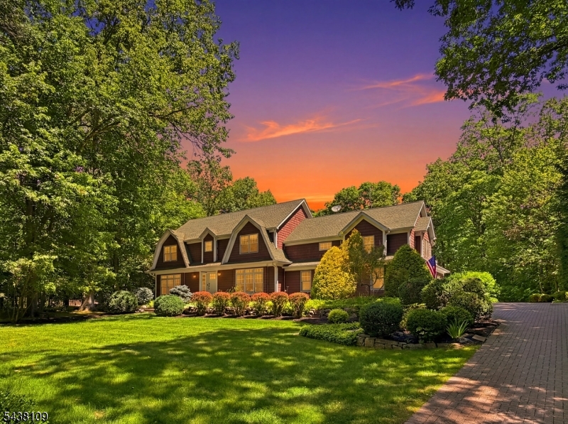 Discover the epitome of refined elegance in this stunning turnkey Custom Colonial residence, nestled within the prestigious gated Smoke Rise community of Kinnelon. This enclave delivers a coveted lifestyle of sophistication and joy, complete with fine dining options, a private beach, tennis club, fishing, swimming and 24/7 gated security. Set on a beautifully manicured ground with mature landscaping, this meticulously maintained 5-bedroom, 4.5-bath home offers exceptional indoor-outdoor living and timeless charm that feels both grand and inviting. Step inside to discover bright, airy interiors with soft neutral tones and elegant picture-frame & base molding, adding warmth and sophistication. To the left of the entrance foyer lies a serene dedicated sitting area, an intimate retreat ideal for quiet reflection, reading or welcoming guests. The sun-drenched living room is a showstopper, featuring sweeping views of the lush grounds, a striking stone fireplace and seamless access to the patio overlooking the IG pool. Adjacent, the gourmet kitchen flows effortlessly into spacious, dedicated dining room, perfect for both meals & memorable entertaining. On the first floor, the primary suite provides a private sanctuary with luxurious spa-inspired jetted bath and generous closet space. An add'l stairway leads to a versatile bonus bdrm suite or great rm complete with a balcony. Every detail has been thoughtfully curated; this could be yours!