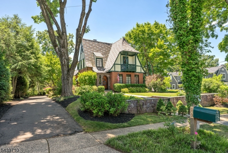 Timeless Tudor Charm in an Unbeatable In-Town Location! Nestled just moments from Oak Street Elementary school, this beautifully maintained Tudor blends historic character with modern comfort. Rich woodwork, arched doorways, hardwood floors, exposed beams, and stunning stone fireplaces showcase the craftsmanship and architectural details that make this home truly special. The spacious kitchen features custom cabinetry, premium appliances, a large center island and an adjoining dining area for everyday living and entertaining.  Generous living spaces are filled with natural light and overlook the private outdoor patio and mature landscaping. The primary suite offers a unique retreat with access to a private balcony.  Enjoy the convivence of an in-town lifestyle with easy access to schools, parks, shopping, dining and transportation.  A rare opportunity to own a distinctive Tudor home where classic elegance meets modern living.