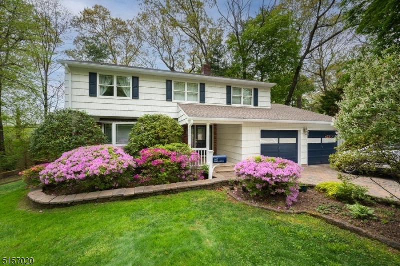 Spacious colonial on quiet, tree-lined street in desirable Park Section of town. Wonderful curb appeal, from paver driveway and walkway to concrete covered porch and mature landscaping. Beautiful hardwood floors throughout first and second floors. Bay windows add light and charm to living room and dining room. Well-appointed, eat-in kitchen has tons of storage, stainless appliances, and sliders to an oversized deck. Cozy family room off kitchen features wood-burning fireplace. (No known issues, but chimney being sold AS-IS.) Half bath, laundry/mud room round out first floor with desired conveniences. Second floor primary bedroom has walk-in closet and en suite with stall shower and double sink vanity. Large finished basement features built-in bar. Oversized deck and private yard perfect for entertaining or relaxing. Close proximity to everything: historic main street shopping district, weekly farmers market, parks and hiking trails, and local YMCA. Commuter's dream with bus and train to NYC and easy access to major highways. Free public preschool to all town residents. This is a must see.