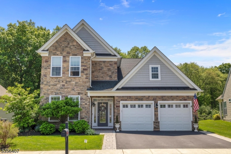 Completely upgraded Bronson Country Manor model in special rare location backing to woods, in the desirable Regency at Flanders 55+ community! A two story foyer welcomes you with engineered hardwood flooring. There's a guest room / study on the first floor along with conveniently located laundry room and entry to oversized 2 car garage with openers. Open concept living space includes 2 story living room, formal dining room area with tray ceiling and gourmet white kitchen with quartz countertops, higher end stainless steel appliances, as well as custom mirrored tile backsplash. Spacious primary suite features bedroom with tray ceiling, walk-in closet, double closet and luxurious bathroom with double vanity, walk-in shower with bench. Second floor offers a 3rd bedroom, full bath with tub shower and loft area, open to family room below. Gorgeous views of surrounding mountains from private paver patio surrounded by blooming hydrangeas and stone retaining walls, covered porch area, outdoor kitchen with Weber grill, custom landscaping, and more! Other custom upgrades include automatic generator, alarm system, irrigation system, extensive custom moldings, 9' ceilings and so much more. Community amenities include pool, club house, fitness center, sport courts and miles of sidewalks. Flanders Valley Golf Course is across the street from Regency. Wrought iron patio furniture remains.