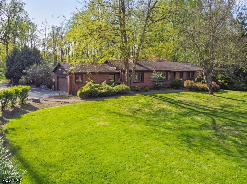 A Private Resort-Style Oasis: Experience the perfect harmony of privacy and sophistication on this beautiful flat 1.68-acre estate in a premier location offering tremendous potential to expand or update. This classic full-brick ranch offers 3,485 total square feet of living space and a breathtaking, resort-style backyard oasis. Designed for the ultimate "staycation," the grounds feature a gunite pool (renovated 2018) framed by an expansive patio and a lush yard. There are numerous arborvitae plantings, and every inch of this flat, usable property exudes curb appeal. Designed for Entertaining. The main level offers an effortless, functional layout with three bedrooms and two baths, a Living/Dining Room, Kitchen open to a Family room with sliders for easy access to the backyard. The lifestyle expands in the 2014 refinished walk-out basement, which serves as an entertainment powerhouse featuring: Recreation Hub: Large rec room with a custom bar. Wellness & Utility: Private gym, full bath, and laundry. Indoor-Outdoor Flow: Direct access to the pool and patio. Premium Upgrades: 2026: New garage door, 2020: New Boiler, 2018: New A/C & 2 bathroom renovations, 2014: Whole-house generator. Rarely does a property combine such peaceful seclusion with world-class amenities. Your retreat is ready.