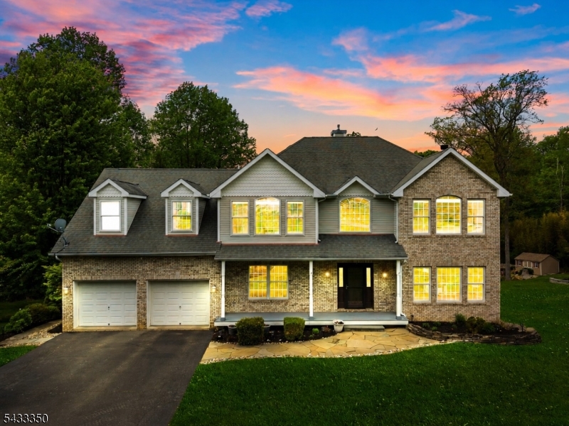 Come fall in love with this stunning 2003-built 4BR Colonial set in a desirable 10-home subdivision on the Byram/Sparta border. From the moment you arrive, the custom masonry mailbox and paver driveway apron set the tone no detail overlooked on this private 3.22-acre lot. Inside, a dramatic two-story foyer welcomes you. The high-end kitchen features 42" cabinetry, granite island, recently replaced stainless steel appliances, double wall ovens, cooktop, wine refrigerator, hardwood flooring, and sliders to an oversized multi-level deck. The main level also offers a living room with wood-burning fireplace, dining room, office, powder room, laundry, and on-grade garage access. Upstairs you'll find 4 bedrooms and 3 full baths but the bathrooms are the true showstoppers. The primary suite features dual walk-in closets and a magazine-worthy bath with striking onyx-look porcelain tile, glossy white flooring, freestanding soaking tub, and oversized glass-enclosed shower with waterfall head and frameless finishes. The secondary bedroom also offers dual closets, while the additional bedrooms each feature two closets for exceptional storage. The second bath impresses with a 72" double vanity in a driftwood oak finish and dramatic full-height accent wall. The fully finished basement offers high-end finishes, wet bar, kitchenette, and large center island perfect for entertaining. New deck in 2021, home was converted to natural gas, and a new water heater was installed.