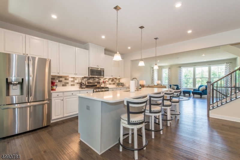Want NEW without the wait? Here it is! Luxuriously upgraded throughout.  Customized McPherson Model with 4' whole house extension, gorgeous upgrades. 2nd floor laundry. ALL warranties in place! Spectacular End Unit in upscale "Mountain Ridge" w/open floor plan FABULOUS OPPORTUNITY to move into a brand new community without the wait. Expanded model offering an amazing gourmet Kitchen w/ breakfast bar & separate office Area. Spacious Master Bedroom Suite w/ customized walk-in closet. Spa-like Master Bath w/double vanity & Roman shower.  Beautiful deck overlooking protected woods.  Sensational walk-out lower level. One of the best lots in this sought after development! Ready to move in! Community offers state of the art clubhouse, walking trails and playground. Don?t miss out on owning this rare townhome!