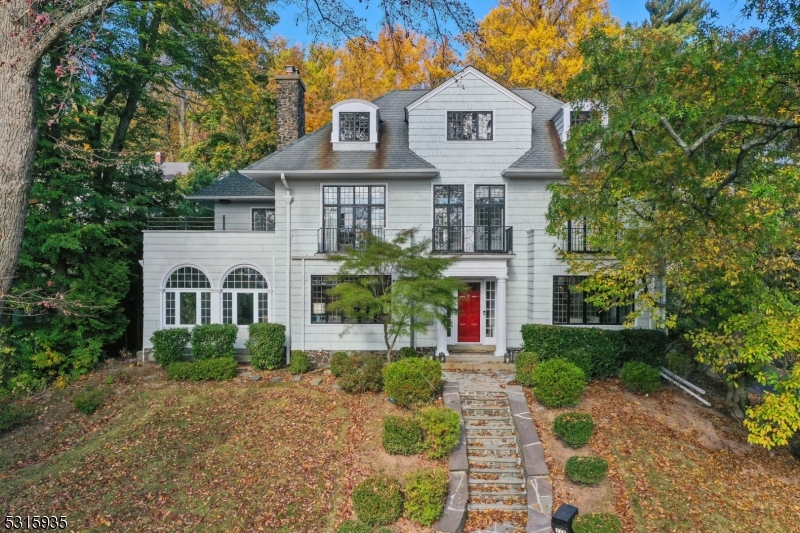One of Wyoming Avenue's most iconic homes, this stunning luxury property sits just 1/2 mile from vibrant Maplewood Village & NYC trains. The interior has been thoughtfully designed to exude comfortable elegance, with generous living spaces across 4 finished levels. Sun-drenched rooms offer treetop views through period leaded glass windows. The fully custom chef's kitchen features high-end professional appliances by Wolf/SubZero, including a 36" dual-fuel range and 48" pro-series built-in fridge with glass door, Danby marble counters, hardware by Buster & Punch and Waterstone fixtues. Built-in and counter seating, access to the stone terrace and a convenient scullery with wine cooler complete this instagram-worthy space. The dining room features designer lighting, wall coverings & built-in storage. The living room fireplace mantle is a notable piece thought to be salvaged from the home of Henry Ward Beecher, brother of Harriet Beecher Stowe. The private primary suite boasts a sitting room with built-ins, a walk-in closet, en-suite bath with double sink vanity, steam shower, heated floors & Samuel Heath fixtures. Additional bedrooms, 3 full baths, home gym flex space & ample storage complete the upper levels. The lower level offers incredible space to relax & unwind plus wine storage, room for game tables, half bath, and laundry. Backing to a quiet lane, find an oversized 1/2 acre property with mature trees, greenhouse, sprawling lawns and access to South Mountain reservation.