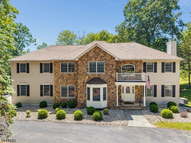 Gracefully positioned on 5 stunning acres with a coveted Califon address, this stately Colonial is a rare offering that blends timeless architecture with modern functionality. Beautifully maintained, the home makes a memorable first impression with its sweeping circular driveway and striking stone-accented exterior. Step inside the impressive two-story foyer, where a spacious formal Dining Room and elegant step-down Living Room are enhanced by decorative columns and lead into the inviting Family Room. Exquisite custom millwork and refined architectural details are showcased throughout the home. The expansive gourmet kitchen is designed for everyday living and effortless entertaining, featuring quartz countertops, ss appliances, center island and abundant custom cabinetry. Completing the main level are a private home office, a well-appointed laundry room, and an elegant powder room. Upstairs, the luxurious primary suite, featuring tray and vaulted ceilings and jacuzzi soaking tub, is joined by four generously-sized secondary bedrooms, three full bathrooms, and extensive closet space throughout. The finished lower level offers an abundance of flexible space, including multiple recreation and gathering areas, and a convenient half bath ideal for entertaining, hobbies or home gym. Outside, the park-like five-acre property provides privacy and beauty. The expansive deck, including a charming gazebo and hot tub, and grounds offer endless possibilities for recreation and relaxation.