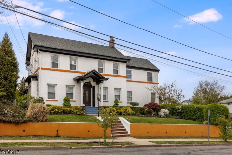 This stunning 1920s center-hall colonial effortlessly combines timeless charm with modern comfort. The first floor boasts a sun-filled family room, an open kitchen with a breakfast bar leading to sliders and the backyard, formal dining room, living room with a beamed ceiling, cozy fireplace, and powder room. Upstairs, huge primary suite features  full bath, an office, and tons of closet space, along with two more bedrooms and another full bath. The third floor offers two additional rooms and plenty of storage. The finished walk-out basement includes a den, laundry area, summer kitchen, full bath, and plenty of extra space with separate entrance. The great yard features large deck and offers lots of privacy. The property also includes two-car detached garage and separate driveway for additional parking. Newer furnace, central AC, and H/W Heater. Conveniently located near the public library, park, Route 3, Route 46, and the Garden State Parkway, NJ Transit's Clifton Station is also nearby, providing an easy commute to Secaucus or Manhattan. Don't miss this exceptional opportunity!