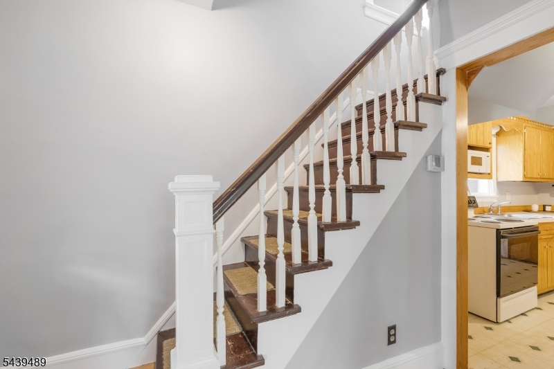 Cozy 3 bed, 2 full bath expanded Cape Cod home with adorable front porch swing across from elementary school!   With brand new carpeting and a fresh coat of paint, the interior feels crisp and current but the character of the 1920s shines through a detailed newell post, staircase and thick molding throughout.  Sizable primary bedroom with main bath on the first floor, and 2 more generous bedrooms and a full bath on the second level.  Lots of natural light pours through the larger windows on both floors, and there are two covered porches on which to relax and enjoy nature or leisure time after a long day.  Full unfinished basement recently painted with new sump pump.  Separate dining area with ceiling fan, and additional ceiling fans in kitchen and primary bedroom.  Close to shopping, transportation with Rt. 287/Rt 28/Rt 22, and Bound Brook train station Raritan Valley line. Barn sold as is.  Same owner for the past 36 years!  You don't want to miss this one!