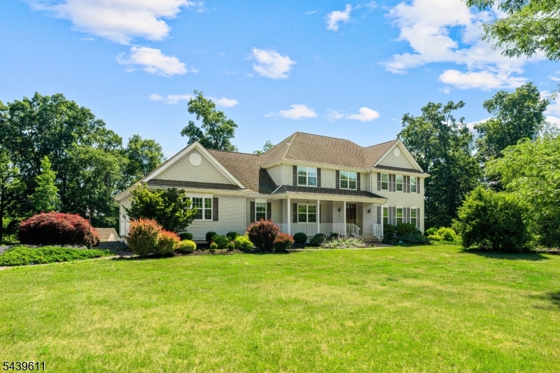 Situated on a beautiful 1.31-acre property, this impressive Center Hall Colonial offers exceptional space,comfort, and versatility for today's lifestyle. A grand two-story foyer welcomes you and is flanked by formal living and dining rooms ,perfect for entertaining.The home's soaring ceilings welcome you with a sense of openness, allowing natural light to fill the space while creating an inviting atmosphere perfect for both everyday living and entertaining. The spacious eat-in kitchen features granite countertops, stainless steel appliances, double wall ovens with a warming drawer, two microwaves, a wine refrigerator, and a wet bar, and opens seamlessly to a warm and inviting family room with a gas fireplace and built-in speaker system. The first floor also includes a bedroom, laundry room, and full bathroom. A three-car garage with new insulated doors and Bluetooth-enabled openers provides ample parking and storage. Upstairs, you'll find four generously sized bedrooms, including a luxurious primary suite with two walk-in closets and a spa-like bathroom with soaking tub, separate shower, two-sink vanities & a private water closet. One of the secondary bedrooms includes a sitting room that can easily serve as a home office,exercise room, or private retreat. The finished walkout basement adds over 1,000 square feet of living space and features a private in-law suite with its own entrance, bedroom,full kitchen,living room,laundry area,workshop,& full bathroom with heated floors.