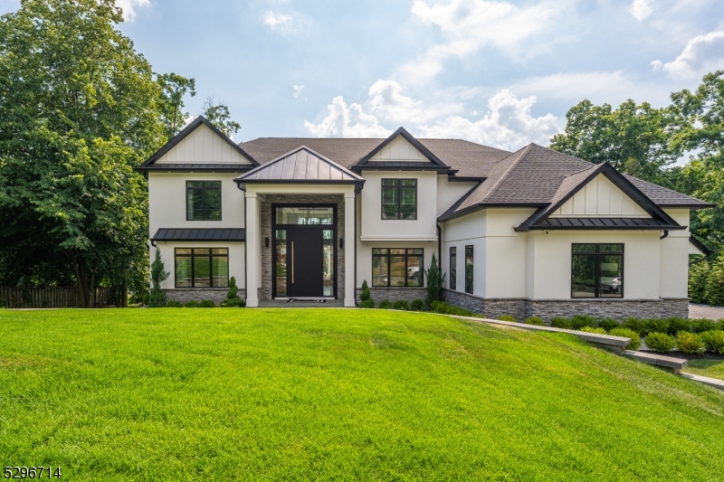 Situated within the prestigious Hills section, this exquisite colonial, built in 2020, offers a sense of seclusion while being local to shopping, dining, schools, and amenities. The grand two-story foyer welcomes you into a luxurious, naturally lit living space that flows seamlessly from the living room to the dining room and into a chef's dream kitchen that boasts custom cabinetry, a center island, and top-of-the-line appliances, including a Wolf stove top and dishwasher, and a Sub-Zero fridge, microwave, and double oven. A cozy family room complete with an electric fireplace, a half bathroom, and a home office round off this level. Ascend stairs to discover a lavish primary suite with an en suite bathroom, a walk-in closet, and a private balcony to soak in breathtaking views. A princess suite with its own bathroom, two additional bedrooms, a common bathroom, and a convenient laundry room equipped with a washer and dryer make this level perfect for everyday living. The finished basement offers endless possibilities with a billiard room, an additional bedroom, a full bathroom, and a gym. The exterior of the home is equally impressive, showcasing a stunning combination of stone and stucco with wood details, and Hardie siding that exudes curb appeal. Unwind on the deck or patio and experience the pinnacle of luxurious living as you witness unparalleled sunsets from the comforts of your own backyard. This is more than just a house; it's your new way of life.