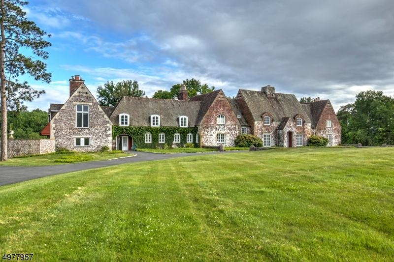 UNIQUE PROPERTY- French Manor style home located on the most magnificent property with pond and pastoral views. This home is all brick with tile roof & Ivy covered walls, with a 3 BRM guest house. A RARE FIND LOCATED ON A COUNTRY LANE - Exquisite home with courtyard in gorgeous property-The home and property boast almost 36 acres, Tennis Court (as is), Gazebo, Pool, Courtyard, extras Garages, Butler's Pantry, and great and unique architectural details through out. There is total privacy and serenity but still this property is very close to town, schools, shopping and just a few minutes to vibrant Morristown, train stations and major commuting roads. Seller has combined some of the bedrooms into a big master bedroom with huge bath and walk-in closets. Lots of room to work, learn and entertain from home.