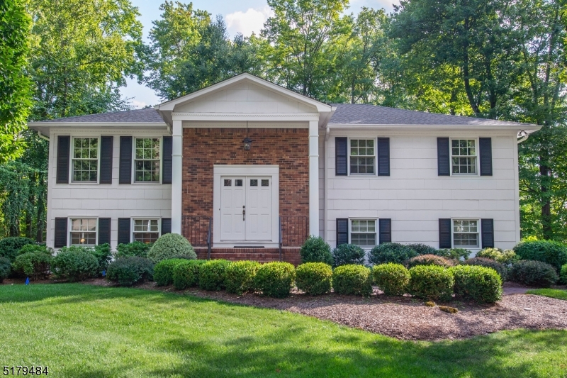 Immaculate, Bright Custom Bi-Level. Quality craftsmanship & fine detailing throughout. Located on a large, private, wooded lot in Great Neighborhood. Lots of Generous Room Sizes to Spread Out & Make Your Own! Layout offers versatile options! GREAT house for entertaining or everyday living. Large living room & formal dining room w/built ins & french doors to back deck. Bright, eat-in kitchen -slider to back deck. Abundance of high hats -Lots of light! 3 large bdrms & 2 full bath upstairs includes the primary suite w/bath (stall shower). Oak hardwood flooring throughout, under carpet upstairs. 4th bdrm on lower level. Fully equipped w/powder room with option & space to convert to full. Family room w/picture window walks out to the lower deck. Convenient laundry/mudroom. 2 car oversized garage. Over 2300 sqft of living. The backyard is large, level and private, completely fenced in! Tons of parking, flat driveway! Largest lot in Country Villages Estates development! 3 quarters of an acre. An ideal spot to relax & enjoy life. Excellent eastern end of town location, with easy access to Morristown Green & NYC-direct train/bus stations. Top rated community with excellent schools! Easy access to major highways such as 10, 46, 287 & 80. Public utilities, tons of important upgrades! Whole house 20KW natural gas generator. Newer windows, roof, oversized gutters, water heater & brand new a/c compressor. Home is in the mapped area of Shongum Lake- rights MAY be available to purchase.*