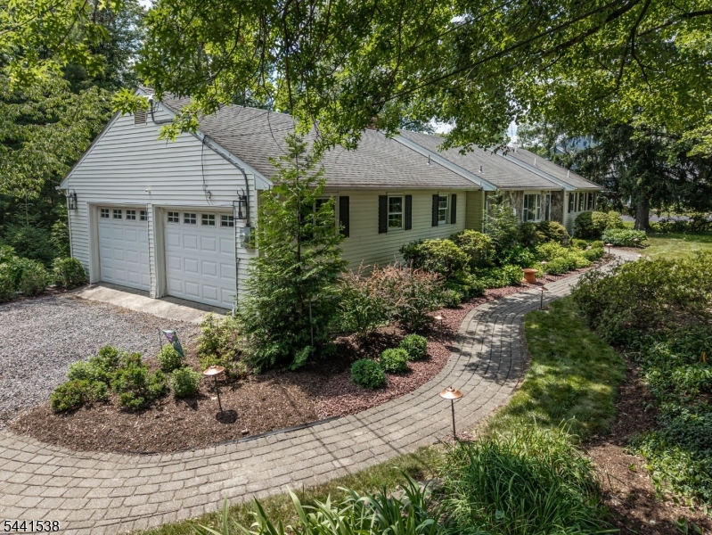 Welcome Home to this well maintained  3-bedroom, 2.5-bath ranch set on a picturesque 0.85-acre lot with a private backyard featuring an expansive tiered deck an ideal retreat for relaxing or entertaining.Inside, you'll find many recent updates! Highlights include  beautiful hardwood floors, updated bathrooms, and a finished family room in the basement, offering additional living space. The updated kitchen boasts granite countertops, white cabinetry, a breakfast bar, and an open layout that flows seamlessly into the dining room & living room ideal for entertaining.The spacious living room is filled with natural light from a large picture window and features a  wood-burning fireplace. The primary suite includes a private full bath with an oversized shower,Additional highlights include a two-car garage and a convenient location close to commuter routes, shopping, and dining.