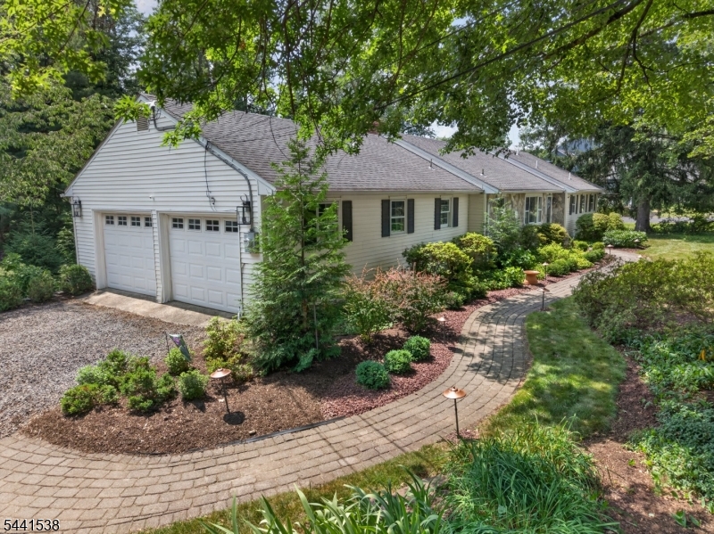 Welcome Home to this well maintained  3-bedroom, 2.5-bath ranch set on a picturesque 0.85-acre lot with a private backyard featuring an expansive tiered deck an ideal retreat for relaxing or entertaining.Inside, you'll find many recent updates! Highlights include  beautiful hardwood floors, updated bathrooms, and a finished family room in the basement, offering additional living space. The updated kitchen boasts granite countertops, white cabinetry, a breakfast bar, and an open layout that flows seamlessly into the dining room & living room ideal for entertaining.The spacious living room is filled with natural light from a large picture window and features a  wood-burning fireplace. The primary suite includes a private full bath with an oversized shower,Additional highlights include a two-car garage and a convenient location close to commuter routes, shopping, and dining.