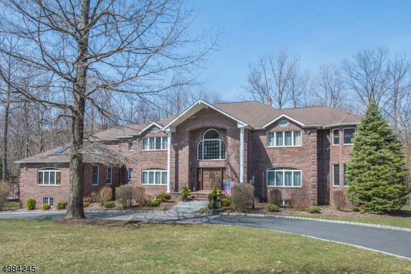 WELCOME HOME.,Double doors open into a majestic, dramatic 2 story entry. Open floor plan perfect for comfortable everyday living and grand entertaining. Quality craftsmanship, architectural details, custom millwork ,designer touches and HDW floors throughout. Impressive  2 stry Great room with floor to ceiling Stone FPL,  open to Custom Kit. State of the art S/S appliances, center island, granite counters and walk-in pantry .The 2 separate wings of the home offer multiple options for living .Lib, 5th Bdrm ,bath on one and FR, office ,1/2 bath on the other.. 3 Oversized bedrooms , Spacious Master suite ,sitting room and full bath fill the 2nd level. Additional entertaining in the w/o lower level includes a home theatre, gym and play room. Enjoy sitting on the deck and enjoy the privacy and nature. 4 car gar.