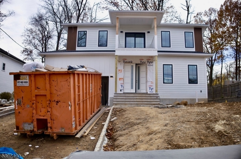 Welcome to 36 Crestview Hill Rd , Build by one of Essex County's premier builders, ICCONIC Builders. This home is conveniently close to houses of worship, top-rated schools, and major highways. offering approximately 3,500 sq. ft. of luxurious living space, this residence features 6 spacious bedrooms, 5 elegantly appointed bathrooms, and a stylish powder room, seamlessly blending modern luxury with functional design. As you enter the two-story foyer, you'll be greeted by an open layout that showcases sophisticated living and dining areas. The sunlit two-story family room is an inviting space for relaxation. The gourmet kitchen is a chef's dream, equipped with premium Thermador appliances, and it conveniently connects to a mudroom and a two-car garage. The first-floor ensuite offers flexibility, making it ideal for guests. Upstairs, the primary suite is a true retreat, featuring a custom walk-in closet and a spa-like bathroom complete with luxurious finishes. This level also includes a vaulted-ceiling bedroom with an en-suite bathroom, as well as two additional bedrooms, a full bathroom, and a dedicated laundry room. The walk-up lower level is designed for entertainment and relaxation, featuring a well-equipped gym, a media room, and a spacious recreation area complete with a wet bar. The lower level also includes an additional bedroom and a full bathroom, providing ample space for guests. all square footage is approximate.