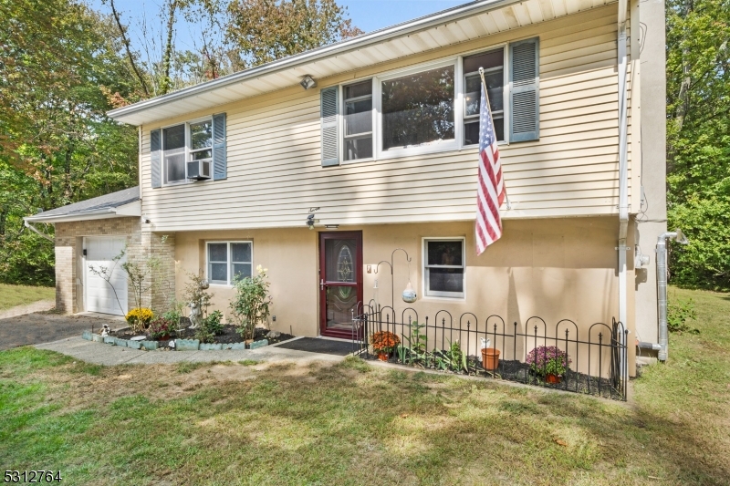 Welcome to this charming 3-bedroom, 1-bathroom home, nestled on a spacious and private level lot (almost a half acre). This property combines tranquility with convenience, making it an ideal retreat. As you step inside, you'll be welcomed by a bright and inviting family room with brand-new flooring, perfect for hosting gatherings or relaxing after a long day. Just off the family room, you'll find a laundry and storage area on one side, with a utility room on the other. The ground floor also features a bedroom for added convenience. This floor is plumbed for a second bathroom for future added bathroom. Upstairs, you'll discover a beautifully updated kitchen with granite countertops, modern appliances and new flooring, seamlessly flowing into a cozy dining area and additional family room. The second floor is completed by two more bedrooms and a full bathroom. Outside, recent updates include a brand-new roof (2024) and newly installed back deck stairs (2021). The expansive flat yard is a rare find in Hopatcong and offers plenty of room for outdoor activities or simply enjoying the peace and quiet of the serene surroundings. With public sewer and well water making it affordable and worry free. This home is located in a quiet neighborhood, yet close to schools, shopping, and dining, offering the perfect balance of seclusion and accessibility. This home is ready to welcome its next owners with warmth and comfort! Not in a flood zone.
