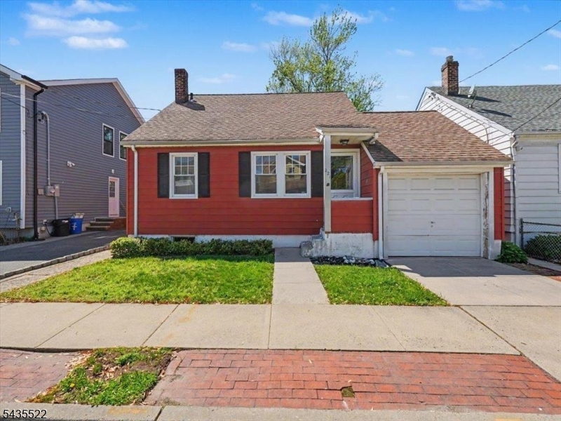 Welcome to this charming single-family home located in the desirable Valley neighborhood of Belleville. This classic-style residence offers a flexible layout with comfortable living spaces and timeless character. The main level features a living room, two versatile rooms suitable for a variety of uses, a spacious eat-in kitchen, a full bath with tub, and original hardwood floors.Upstairs, a finished room beneath the eaves provides an ideal guest space or home office and connects to additional attic storage. The finished basement adds valuable bonus space with a cozy den anchored by a wood-burning stove, a laundry area, a 10-foot workbench, and ample storage.Just off the kitchen, a bright mudroom opens to a fenced backyard featuring a stone-paver patio, lawn, and mature plantings perfect for entertaining, gardening, or relaxing outdoors. Central A/C, a dedicated driveway, and a one-car garage add comfort and convenience.Conveniently located near schools, public transit, downtown Belleville shopping, and parks, this long-time owner-occupied home is being sold as-is, offering an excellent opportunity to update and personalize a classic property.
