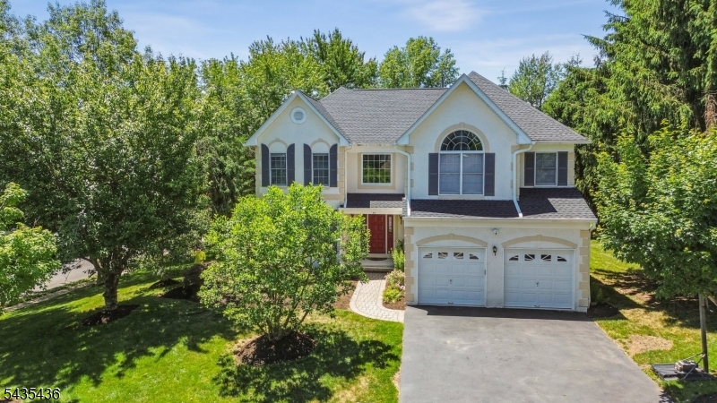 Welcome to 59 Ramapo Drive, a Richmond model in Patriot Ridge, one of the most sought-after sections of The Hills in Basking Ridge. Set on a 0.30-acre corner lot, this 3,457-square-foot home offers four bedrooms, two and a half baths, and an open floorplan within the well-built footprint that defines this established Bernards Township community. A northeast-facing entrance opens to a sunny foyer and a welcoming space inside, where hardwood floors run through the main living areas. A sun-filled solarium adds a bright, flexible space for relaxing or entertaining, and the primary suite features an updated bath. A standout feature is the unfinished walkout basement with high ceilings, a true blank canvas for the next owner, opening directly to a paver patio and the rear yard. A two-car attached garage with an epoxy-finished floor adds everyday function, and the corner-lot setting provides extra space and privacy. Recent updates include HVAC replacements in 2019 and 2020 and a new hot water heater in 2024, new roof and gutters in 2024. Located in The Hills, this home is close to schools, parks, shopping, and major commuting routes to NYC. Solid construction, generous square footage, and exceptional expansion potential make 59 Ramapo Drive a compelling opportunity in a strong market.