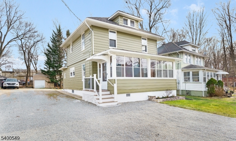 Step into modern comfort wrapped in timeless charm in this fully renovated colonial tucked away on a quiet street in Rockaway Boro. Carefully redesigned while preserving its historic soul, this home offers 3 bedrooms, 2.5 baths, and a bright, open kitchen/dining area that's ideal for both everyday living and entertaining.The brand-new kitchen shines with quartz countertops, stainless-steel appliances, new cabinetry, and contemporary hardware. A welcoming three-season front porch expands your living space and adds year-round charm. Upstairs, the relaxing primary suite features an en-suite bath with a spacious shower.Throughout the home, original details like beautiful millwork, stained-glass accents, and vintage hardware create warmth and character, perfectly paired with modern updates that include new electrical and plumbing. Storage is abundant with a walk-up attic and a full basement with laundry. Outside, the long driveway accommodates at least four vehicles, providing convenience for this area.With a location just minutes from Rt. 80, downtown Rockaway Borough, and the Rockaway Townsquare Mall, this move-in-ready home blends accessibility, modern upgrades, and timeless charm.