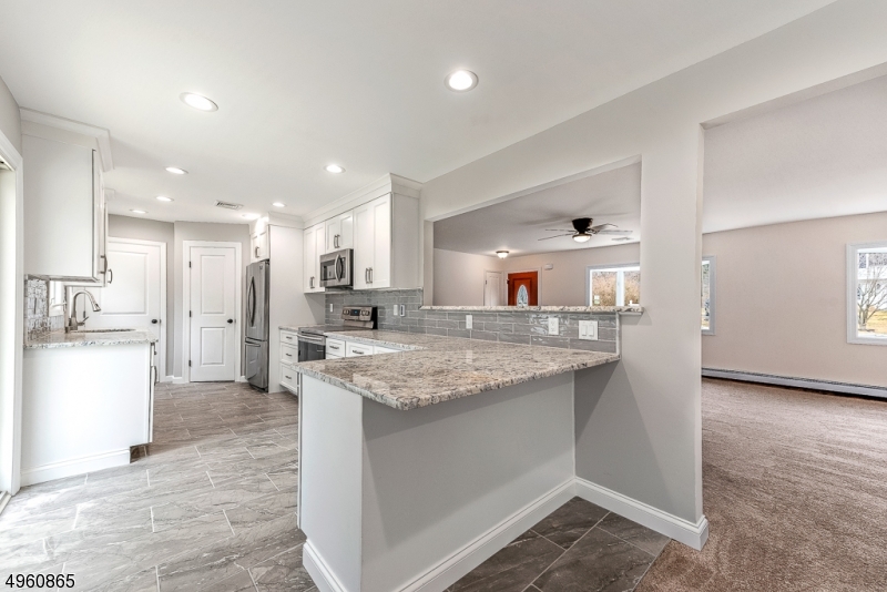 TOTAL RENOVATION! SOUGHT AFTER OPEN LAYOUT RANCH W/ SPACIOUS ROOMS!THIS PROPERTY HAS BEEN COMPLETELY REDONE! BRAND NEW KITCHEN W/ LG BREAKFAST BAR, FAT GRANITE COUNTERTOPS, BEAUT BACKSPLASH, S/S APL LED LIGHTING,  LAR&GE PANTRY STORAGE. DINING AREA HAS BEAUTIFUL VIEWS OF DECK & BACKYARD FROM GLASS SLIDER PROVIDING ACCESS TO DECK. LARGE LIV RM W/ BAY WINDOW PROVIDES NATURAL LIGHT & BRIGHTNESS. SPACIOUS 3 BEDROOMS AND 2 TOTALLY RENOVATED BATHS! ALL NEW EXPERT TILE WORK, FIXTURES AND SOO MUCH MORE! NEWER ROOF, DOORS, &WINDOWS. LG BASEMENT IS PERFECT FOR STORAGE. LG LVL YARD W/ PRIVACY FROM NATURAL SURROUNDINGS. DECK IS PERFECT FOR ENTERTAINING! LOC IN DESIRABLE SEC OF STANHOPE ON CUL-DE-SAC STREET CONVENIENT FOR COMMUTERS CLOSE PROXIMITY TO 206,80, 46. TRAIN STATION IS NETCONG & LOCAL SHOPPING CONVENIENCES.