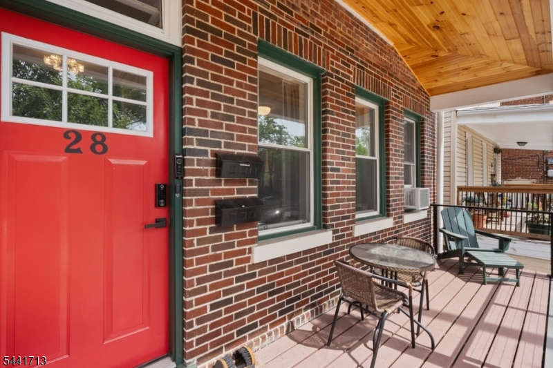Enjoy the perfect blend of historic charm and contemporary comfort in this beautifully maintained residence located on a peaceful, tree-lined street. This classic 1920's brick home greets you with a charming front porch and welcomes you into an inviting entry foyer. Step inside to find a spacious open-concept layout that's flooded with natural light from oversized windows, including three with east-facing exposures. The expansive kitchen features generous counter space, abundant cabinetry and a breakfast bar that flows seamlessly into the living area. Both bedrooms showcase stunning oak wood floors and exposed brick walls, including a primary bedroom with a deep custom closet and a versatile secondary bedroom with direct access to the backyard. The brand-new bathroom is finished with a sleek walk-in shower. Enjoy the convenience of dedicated laundry and storage in the clean walk-out basement as well as the ease of private off-street parking and EV charging availability. Additional peace of mind with fingerprint-activated locks, motion-sensor lighting & security cameras. Can't forget FREE professional monthly cleaning service! This home offers a rare combination of quiet surroundings and exceptional walkability. Ideally situated near Glenfield Park and in walking distance to Bay Street and Glen Ridge train stations. Experience all that Montclair is known for including its vibrant downtown, acclaimed dining, boutique shopping, parks and thriving arts & culture scene.