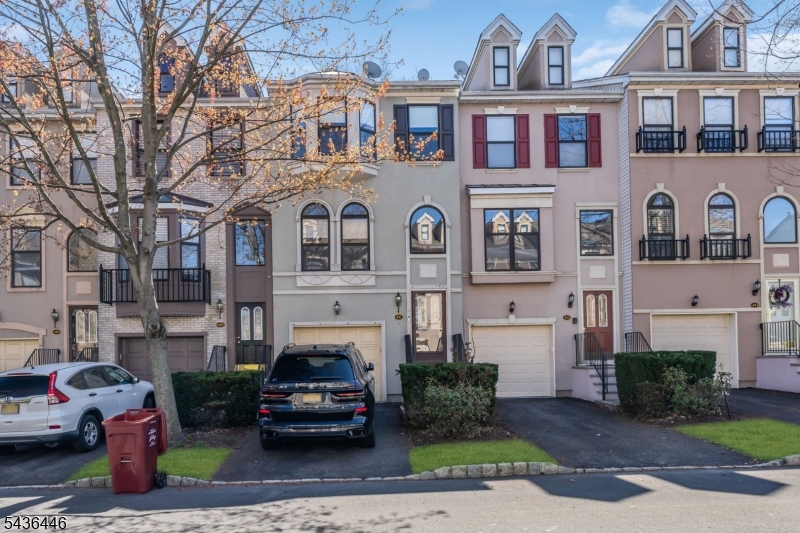 Impeccably maintained and updated Townhouse in the Prestigious Cambridge Heights Complex offering the best possible location near Shopping, NYC Bus, Dining and Schools. This amazing personal residence offers over 2000 square feet of luxurious living space with a View of the grounds and Fountain. The Main Level Features Beautiful Hardwood Floors Throughout with a Spacious Formal Dining Room with Crown Molding and Ample Natural Light, an Ultra Modern Kitchen with Granite Counters, Brilliant White Cabinets, Stainless Steel Appliances and recessed Lighting and a Gorgeous Living Room with a Gas Fireplace, Recessed Lighting and Crown Molding and a Convenient Half Bath. Upstairs you will find amazing Wood Floors, a sensational Master Bedroom Suite with a Vaulted Ceiling, Ceiling Fan, Two Huge Closets and a Spectacular Full Bath wth a Double Vanity, Soaking Tub and Separate Stall Shower, a Second Bedroom with Unique Skylights, a Ceiling Fan and an Oversized Double Closet and a Second Full Bath with a Vanity, Tub and Shower and a Super Convenient Laundry Area.  The Finished Ground Level offers a Family Room with a Second Gas Fireplace, Direct Access to the Backyard and Patio, Recessed Lighting, and Access to the attached garage. The HVAC system is newer and the unit is only Steps away from the playground. The Complex Amenities include a Clubhouse with Exercise Facilities, a Pool, Tennis Court, Lush Landscaping and Gated Security.