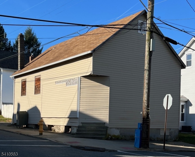 Live, Work, or Invest.  Rare Corner Property in Warren County with Garage, Basement & Endless Possibilities. It offers exceptional flexibility for investors, business owners, or creative owner-occupants. Situated on a prominent corner lot, this unique property allows both commercial or residential use under R-50/R-75 zoning, opening the door to a wide variety of permitted uses. The building features soaring 20 ft ceilings (approximate), a full basement for storage or expansion potential, and a detached one-car garage with off-street parking. A new roof was installed in 2024. The property is currently vacant and ready for renovation, repositioning, or occupancy subject to any site plan approval depending on choice of use.  Previously approved for laundromat use, the space presents strong value-add potential for retail, office, service business, live-work conversion, or possible single-family redevelopment. Ideal for investors, contractors, entrepreneurs, or 1031 exchange buyers seeking a versatile asset at an accessible price point.Bring your vision. Opportunities with this level of zoning flexibility and upside are increasingly hard to find. Buyer to perform all due diligence regarding permitted uses.Permitted uses and resolution available to agents in document link.