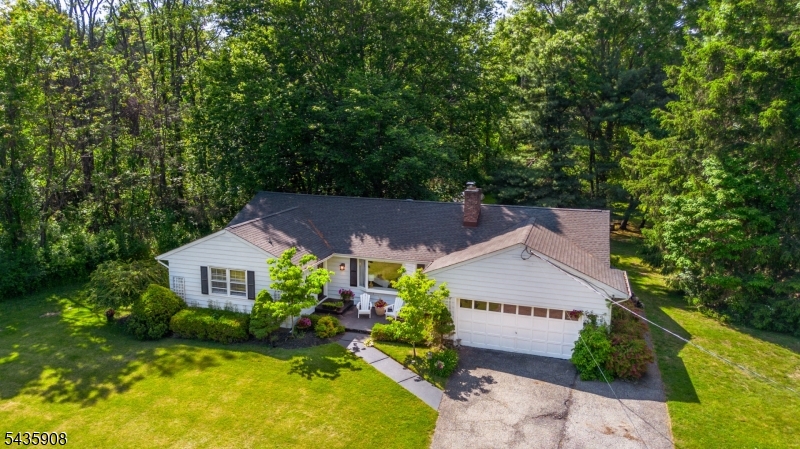 Location Location!Tucked away on a quiet cul-de-sac in one of Boonton Township's most sought-after neighborhoods, this charming ranch offers the perfect combination of privacy, comfort, and convenience. Set on over an acre of beautifully level property surrounded by lush landscaping, mature trees, and a peaceful natural setting, this home feels like a private retreat while still being just minutes from shopping, dining, schools, and major conveniences.Designed for easy one-level living, the home features 3 spacious bedrooms and 2 full baths, along with gleaming wood floors throughout. The inviting kitchen offers stainless steel appliances, tile flooring, a pantry, and a sunny breakfast room overlooking the serene backyard. The expansive living and dining area is filled with warm natural light from a beautiful bay window and centered around a stunning wood-burning and coal fireplace, creating a cozy and welcoming atmosphere. French doors open to a large deck, perfect for entertaining or simply relaxing and enjoying the tranquil surroundings. The generous primary suite includes a private full bath with a stall shower, while a large unfinished basement and 2-car attached garage provide endless possibilities and ample storage. Quiet, peaceful, and exceptionally situated in the sought after Mountain Lakes High School district, Ideally located close to public transportation and under an hour from NYC!