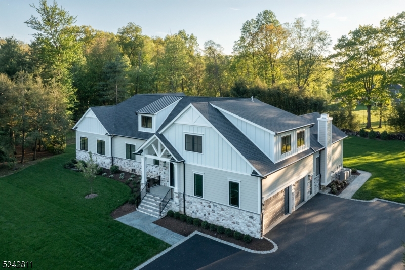 Brand New Luxury Custom Home offering Modern Single-Level Living with a spectacular open floor plan with cathedral ceilings and unparalleled convenience. 6 bedrooms, 5.2 baths, 3 finished levels of 7,000 sq ft including a loft and lower level. Located in a sought after neighborhood and set at the end of a private cul de sac, 1.5 acres of flat property. Exceptional design details, extensive high-end finishes with the highest quality construction, makes this stunning custom home so special. The 1st level boasts a seamless open floor plan; 2 Story foyer and dining room, 5 Bedrooms, 4.1 baths, mudroom, laundry, a gourmet kitchen comes complete w/luxury Thermador appliances, a custom built hood and cabinets, oversized center island with quartz counters and full backsplash, and a show stopping prep kitchen. Kitchen flows seamlessly to the family rm with coffered ceiling & modern gas fireplace. The kitchen leads to the serene expansive sodded yard with a covered patio, sprinkler system, and unobstructed peaceful views. Features include; 3 car garage and wired to charge 1 electric car,10' ceilings on 1st floor, 4" oak HW floors, full house generator, & so much more! On 2nd lvl, you will find a fabulous Loft rm open to main lvl with a full wet bar, full bath, and sprawling office or 6th bdrm. The lower lvl is complete with a bath, sprawling rec space, walk up to the outside, and utility and storage rooms. DREAM location, just 5 minutes to top rated schools, including Pingry School.
