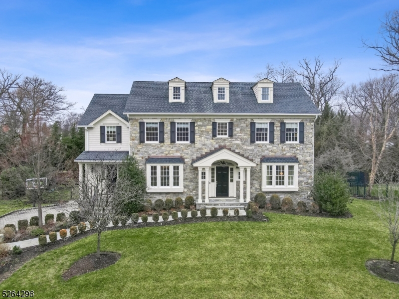 This breathtaking spacious Colonial built by renowned WP Lloyd is sure to impress and offers everything that home buyers want today including architectural interest, an open floor plan, white gourmet kitchen, finished lower level and a private yard perfectly set on a cul-de-sac in the desirable Hill section of Madison. This sun-filled home with four finished levels offers 6 bedrooms and 5.1 baths. The main floor enjoys a large foyer, a banquet size dining room, a living room, a family room with a wall of windows and a fireplace that opens to the breakfast room and kitchen. The kitchen has plenty of custom cabinetry, breakfast bar, Wolf stove, a Wolf wall oven, and a Sub Zero fridge. A walk in pantry, large mudroom with 7 cubbies, butler's pantry and powder room completes this main level. The second level boasts 4 bedrooms all en-suite and a private primary suite with a huge walk in closet and luxurious spa like bath with shower and soaking tub.  Continue to the third level and enjoy a private office that is a versatile space and a 5th bedroom, full bath and 2 storage areas.  The lower level features a recreation room, exercise room, bedroom and full bath and a 2 and 1/2 car garage. The fenced in yard has an expansive bluestone patio with stone fireplace and a built in kitchen, the perfect space to relax, entertain and enjoy the outdoors. Enjoy all Madison has to offer rated #1 town to live in by NJ Monthly in this very special home perfectly built with many upgrades!