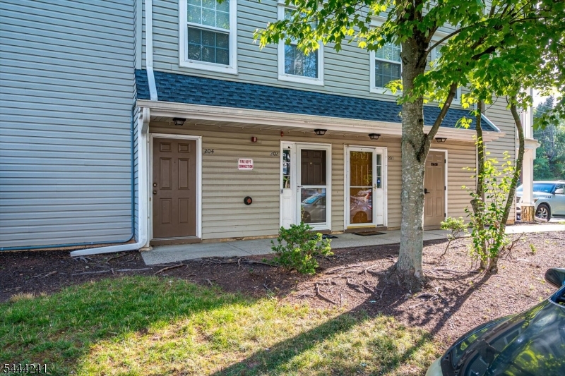 North-East Facing (Buyer to Verify) | Updated Townhome in Village Pointe, EdisonWelcome to this beautifully updated 2-bedroom, 2.5-bath townhome in the desirable Village Pointe community. This well-maintained home offers a functional three-level layout designed for comfortable everyday living.The main level features an open-concept living and dining area with refinished hardwood floors, abundant natural light, and fresh interior paint. The updated kitchen includes custom wood cabinetry, granite countertops, a center island with additional storage, stainless steel appliances, decorative tile backsplash, recessed lighting, and generous workspace.Upstairs, the spacious primary suite offers a large closet and an updated en-suite bath with dual vessel sinks, a soaking tub, and a separate glass-enclosed shower. A second bedroom, full bathroom, and conveniently located laundry room complete the upper level.The entry level features a welcoming foyer with direct access to an oversized attached one-car garage offering additional storage. An assigned parking space provides convenient parking for a second vehicle.Located in a professionally maintained community with mature landscaping, this home is conveniently situated near shopping, dining, parks, major highways, and public transportation. North-East facing orientation is based on available information; buyers are encouraged to verify any features important to them.
