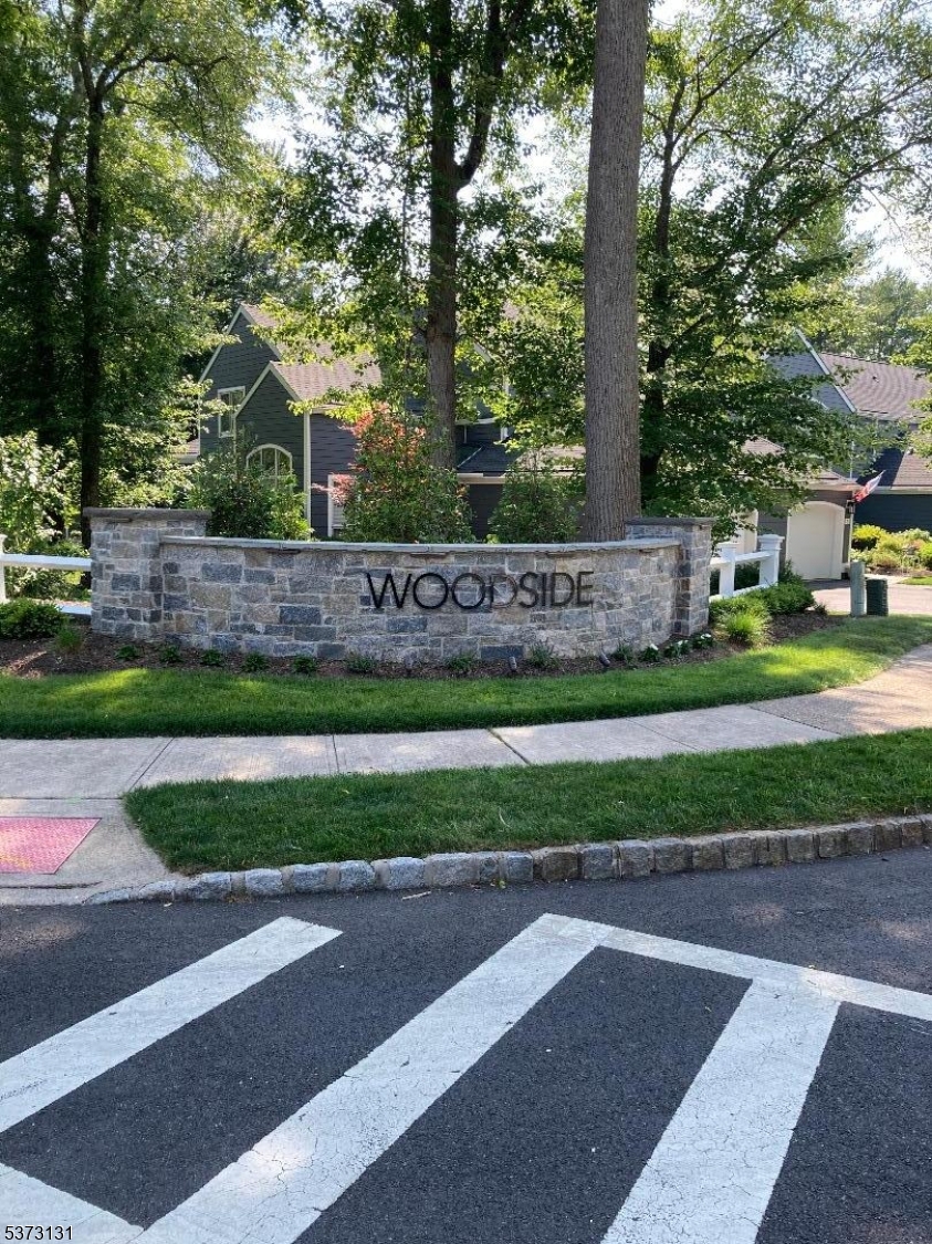 Just renovated, beautiful bright and sunny, large end-unit townhouse in highly desirable Woodside community. New gourmet kitchen with quartz countertops and new stainless steel Samsung appliance package.  Extremely spacious 2BR, 2.5BA with additional large 2nd floor loft/office with new skylight.  House has great flow & floor plan.  Bathrooms updated. New hardwood floors first floor, new carpets 2nd floor and oversized finished basement with new luxury vinyl planking. Also has abundant storage.  Brand new furnace and central air conditioner.  Oversized 2 car garage.  Lighting package.  Private oversized screened in rear porch provides a nice place to sit and relax. The association recently completed extensive exterior renovations to the entire community - siding, roof, lighting, decks, driveways, entrance monuments, etc. Walk to town!!  Very conveniently located to Morristown Field Club, Town of Morristown, and Rt. 287.