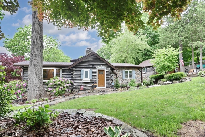 Tucked on a beautifully landscaped corner lot, this one-of-a-kind 3 bedroom, 2 bath log home blends rustic character with modern comfort. Soaring wood-beam ceilings, warm timber finishes, and stunning stonework create the perfect mountain-lodge feel while offering an inviting open layout ideal for everyday living and entertaining. The updated kitchen features granite countertops, abundant cabinetry, and flows seamlessly into the spacious living and dining areas with dramatic ceiling lines and a striking stone fireplace centerpiece. The flexible floor plan includes a dedicated office, gym space, and a finished lower level recreation area with a separate entrance- ideal for guests, hobbies, or work-from-home needs. Step outside to your private backyard retreat complete with beautiful hardscaping, expansive decking, and a freshly lined in-ground pool surrounded by mature landscaping. Additional highlights include a detached two-car garage, whole house generator, and optional membership to either Cupsaw Lake or Erskine Lake, offering year-round recreation and community amenities. A rare opportunity to own a true log home retreat with privacy, character, and exceptional lifestyle amenities in Ringwood. **Multiple offers received. Kindly submit all offers by Monday, 6/8 at 5pm***