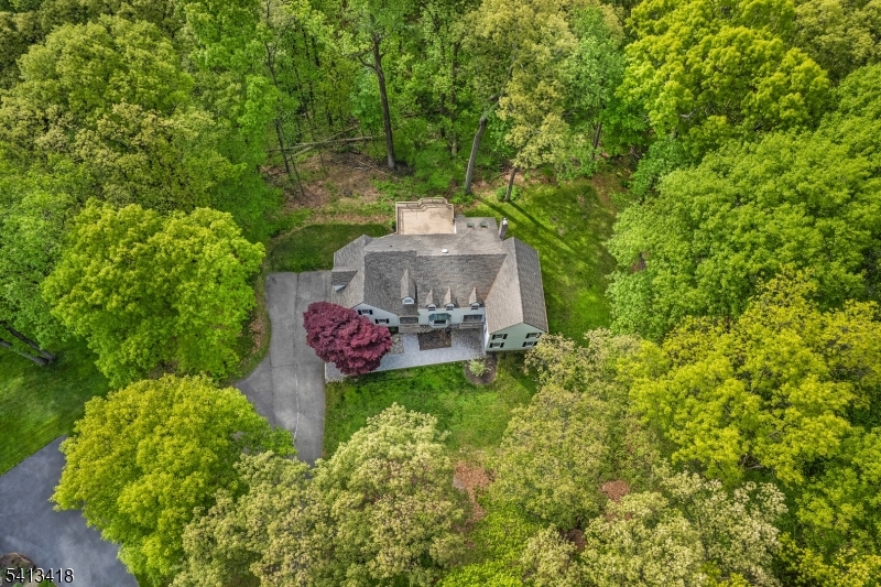 Tucked away at the end of a quiet cul-de-sac on 4.73 breathtaking acres in coveted Chester Township, this fully reimagined 4,437-square-foot Colonial is the definition of modern luxury meets timeless sophistication. Every inch of this four-bedroom, four-bath home has been elevated with intention, from the fresh interior and exterior paint to the wide-plank LVP flooring, designer finishes, and custom architectural details throughout. The heart of the home is a stunning chef's kitchen designed to impress, featuring sleek quartz countertops, premium Caf  Appliances appliances, and an effortless open-concept flow perfect for entertaining on any scale. Sophisticated designer wallpaper transforms the dining room into a true statement space, while custom millwork, elegant paneling, shadow box molding, recessed lighting, and refined trim work create a level of detail rarely found at this price point. The primary suite and guest baths have been beautifully updated with a clean, elevated aesthetic that feels straight from the pages of a luxury design magazine. New interior doors and brand-new garage doors further enhance the seamless, turnkey feel of the home. Set against a backdrop of privacy, mature trees, and picturesque acreage, this is more than just a home, it's a lifestyle property that delivers the rare combination of luxury, land, and location in one of Chester Township's most sought-after settings. Sellers relocating out of state.