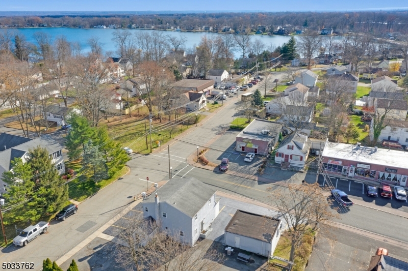 Incredible opportunity with endless possibilities in this mixed-use property with ample parking. Free-standing building in a prime corner location with high visibility in the heart of Lake Parsippany residential neighborhood and just minutes from Routes 80 and 287. First floor was an active pizzeria - all kitchen equipment and furnishings included. Other possible uses- just bring your imagination and verify w/ the town. Live where you work or rent out for additional income w/ the 2BR apartment upstairs (currently rented). Additional detached building w/ storage (currently rented).